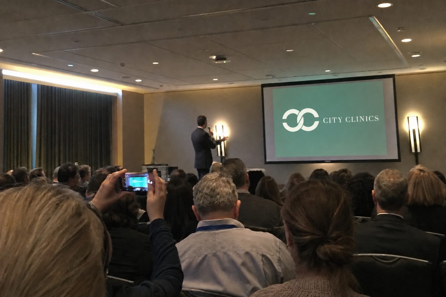 The annual patient seminar — the room, the screen, the questions (illustrative)